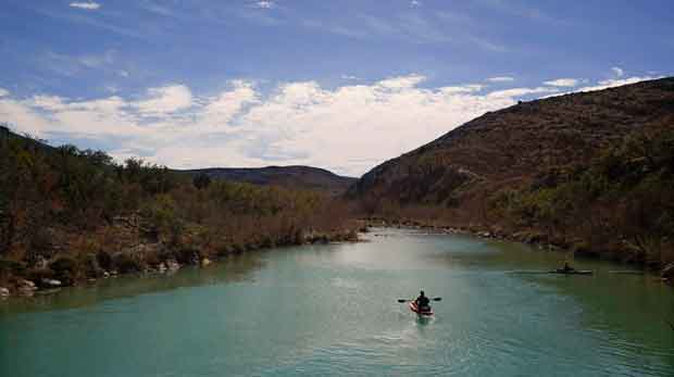 A paddler floats along the Devil's River